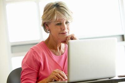 woman reading signs and symptoms of breast cancer